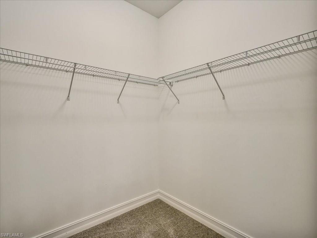 999 Enbrook Loop Naples, FL 34114 - Photo 27 of 50 a view of a room with racks on the wall