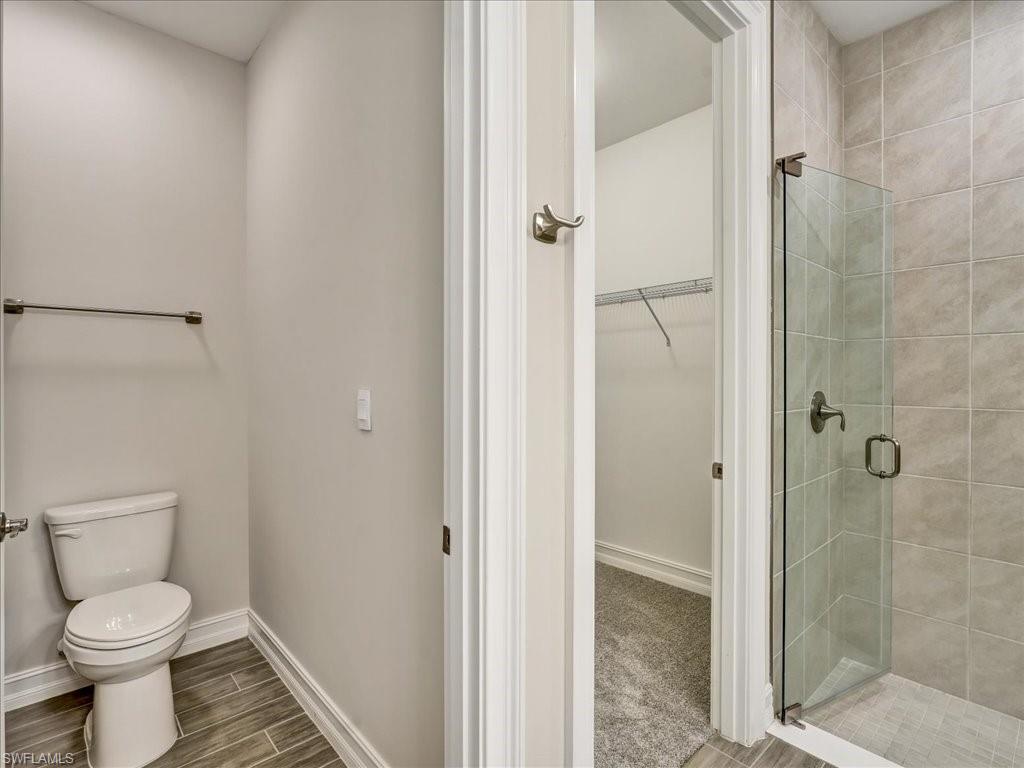 999 Enbrook Loop Naples, FL 34114 - Photo 28 of 50 a bathroom with a toilet and a shower