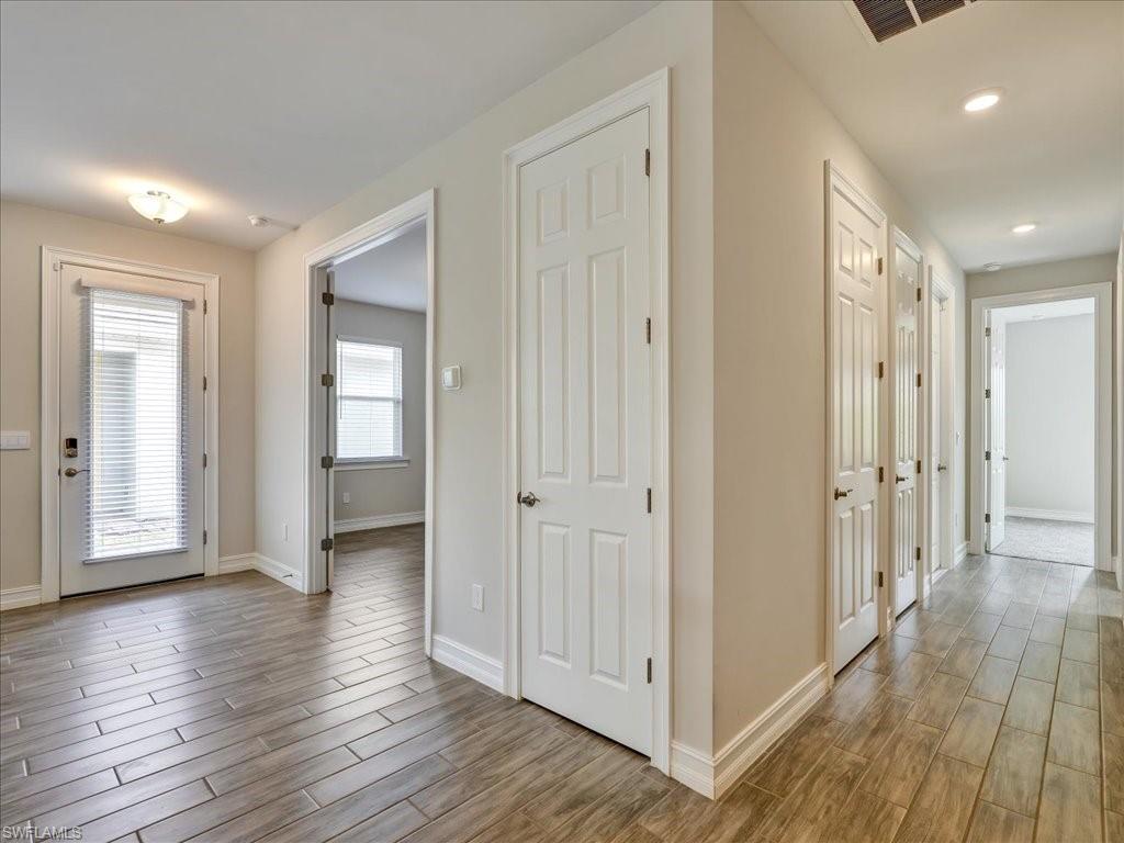 999 Enbrook Loop Naples, FL 34114 - Photo 31 of 50 a view of a hallway with wooden floor