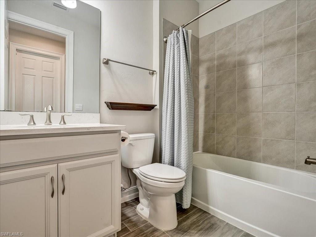 999 Enbrook Loop Naples, FL 34114 - Photo 34 of 50 a bathroom with a sink toilet and shower