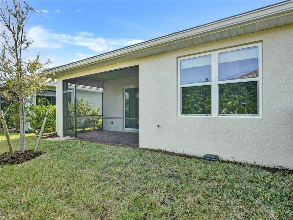 999 Enbrook Loop Naples, FL 34114 - Photo 38 of 50 a view of a backyard with plants and large tree