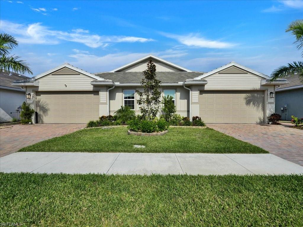 999 Enbrook Loop Naples, FL 34114 - Photo 42 of 50 a front view of a house with a garden