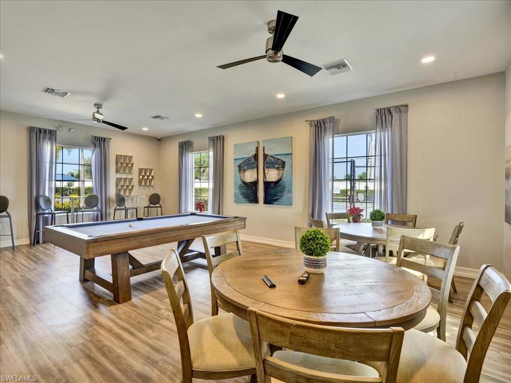999 Enbrook Loop Naples, FL 34114 - Photo 47 of 50 a dining room with furniture a rug and wooden floor