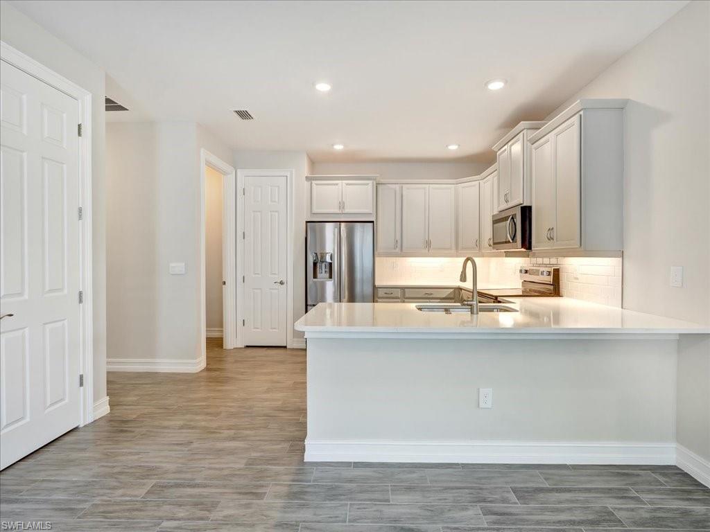 999 Enbrook Loop Naples, FL 34114 - Photo 6 of 50 a view of kitchen with wooden floor