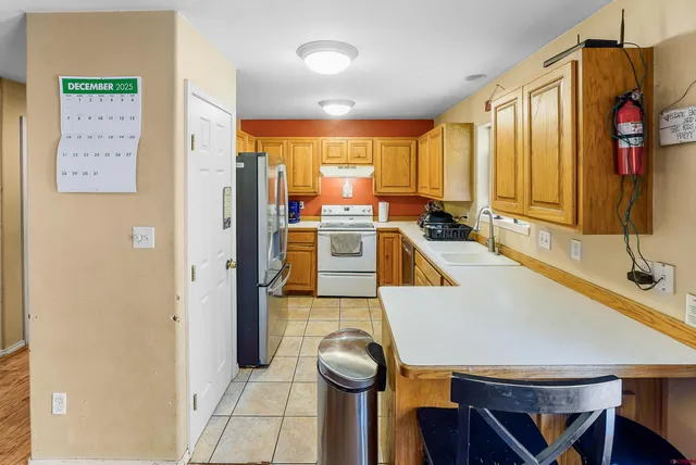 a large white kitchen with a large window