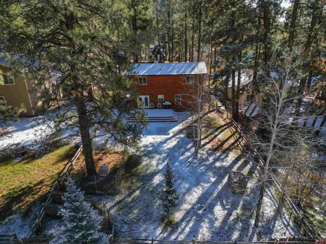 a view of a yard with wooden fence