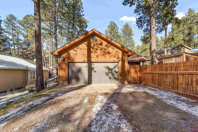 a view of a backyard with a large tree