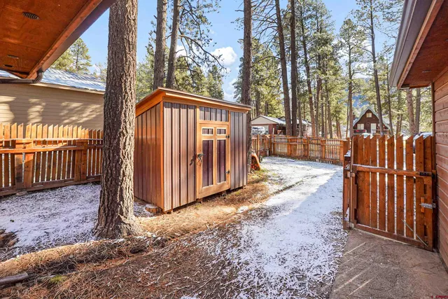 a view of a backyard with wooden fence