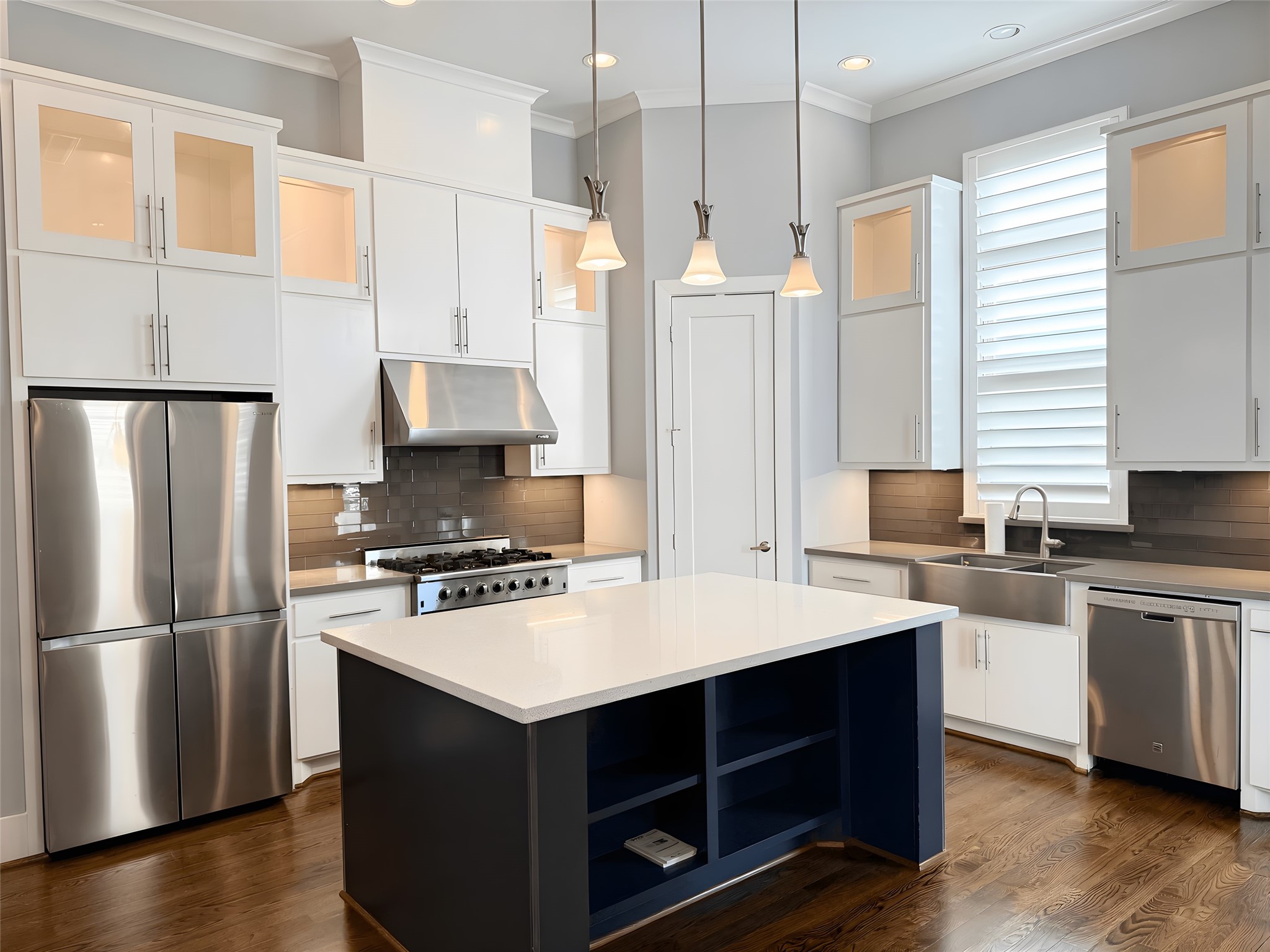 2115 Detering Street Houston, TX 77007 - Photo 1 of 30 a kitchen with a refrigerator a stove a sink and white cabinets