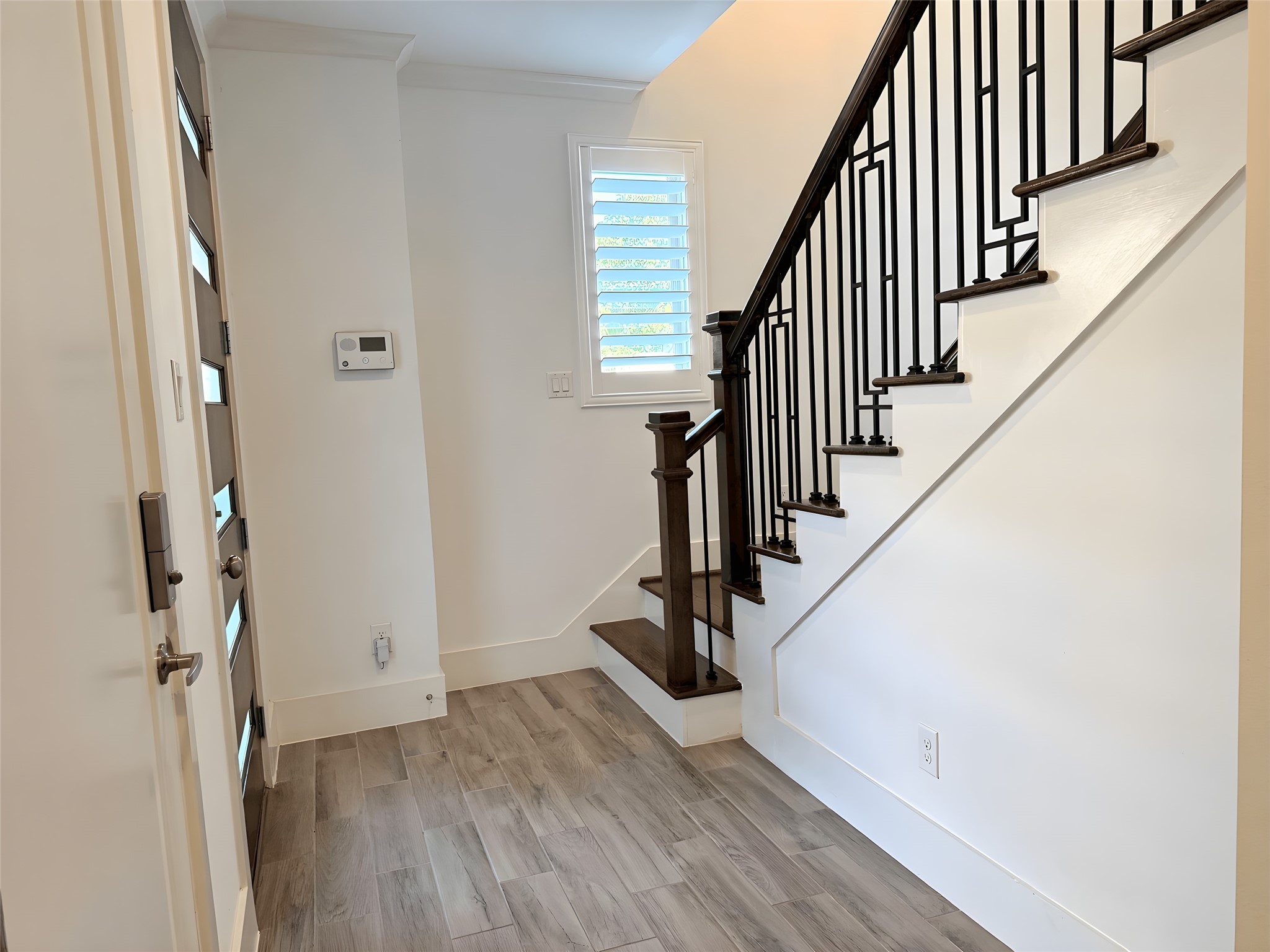 2115 Detering Street Houston, TX 77007 - Photo 14 of 30 a view of a hallway with wooden floor and staircase