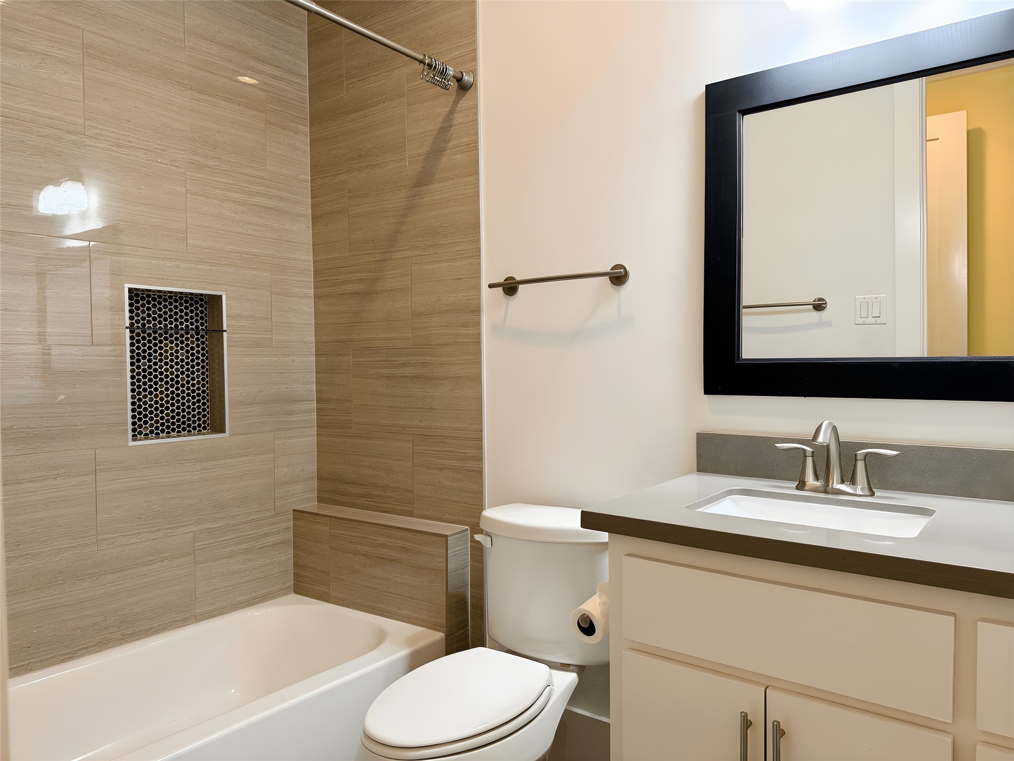 2115 Detering Street Houston, TX 77007 - Photo 22 of 30 a bathroom with a toilet a sink a bath tub and mirror