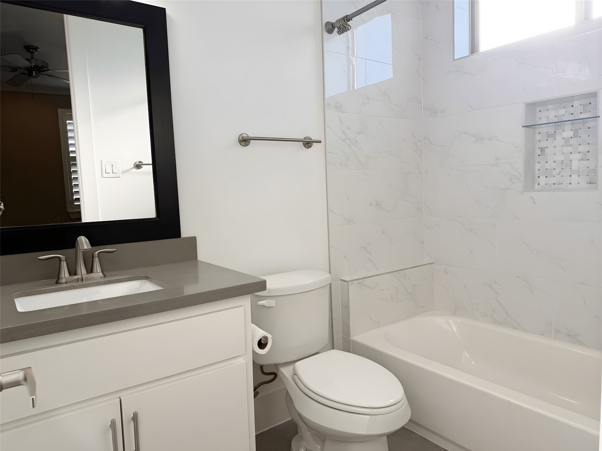 2115 Detering Street Houston, TX 77007 - Photo 24 of 30 a bathroom with a granite countertop toilet sink and mirror