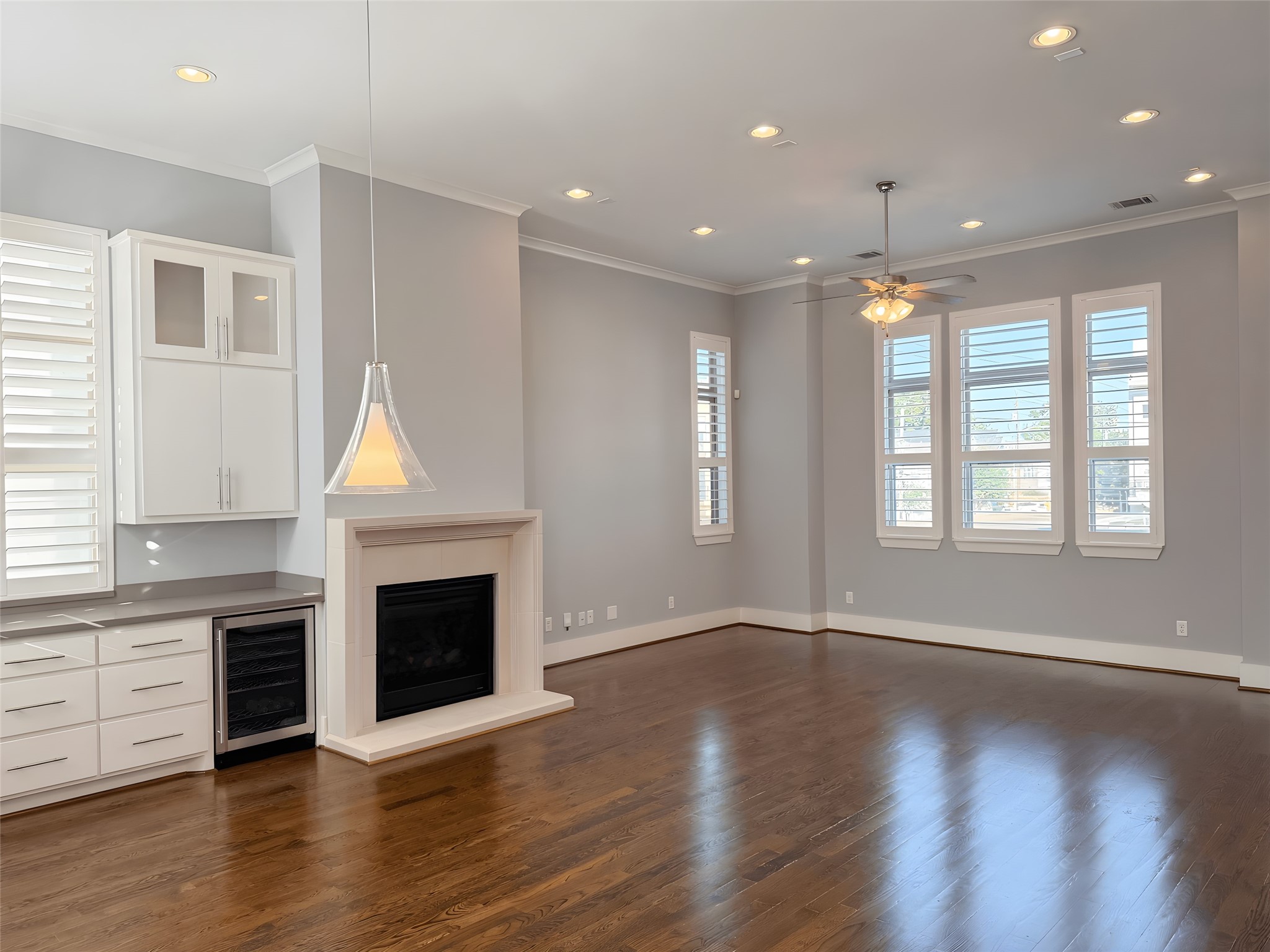 2115 Detering Street Houston, TX 77007 - Photo 5 of 30 an empty room with wooden floor fireplace and windows