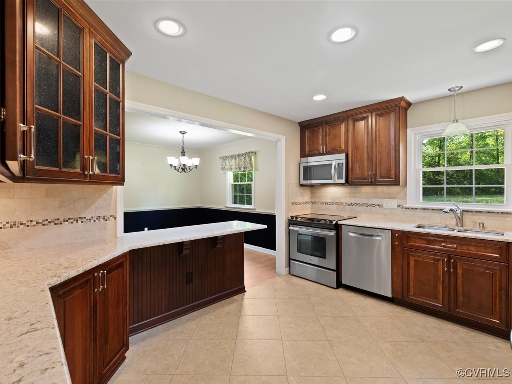 11311 Moravia Road Midlothian, VA 23112 - Photo 12 of 29 a large kitchen with stainless steel appliances granite countertop a stove a sink dishwasher and a microwave oven on the blue kitchen countertops