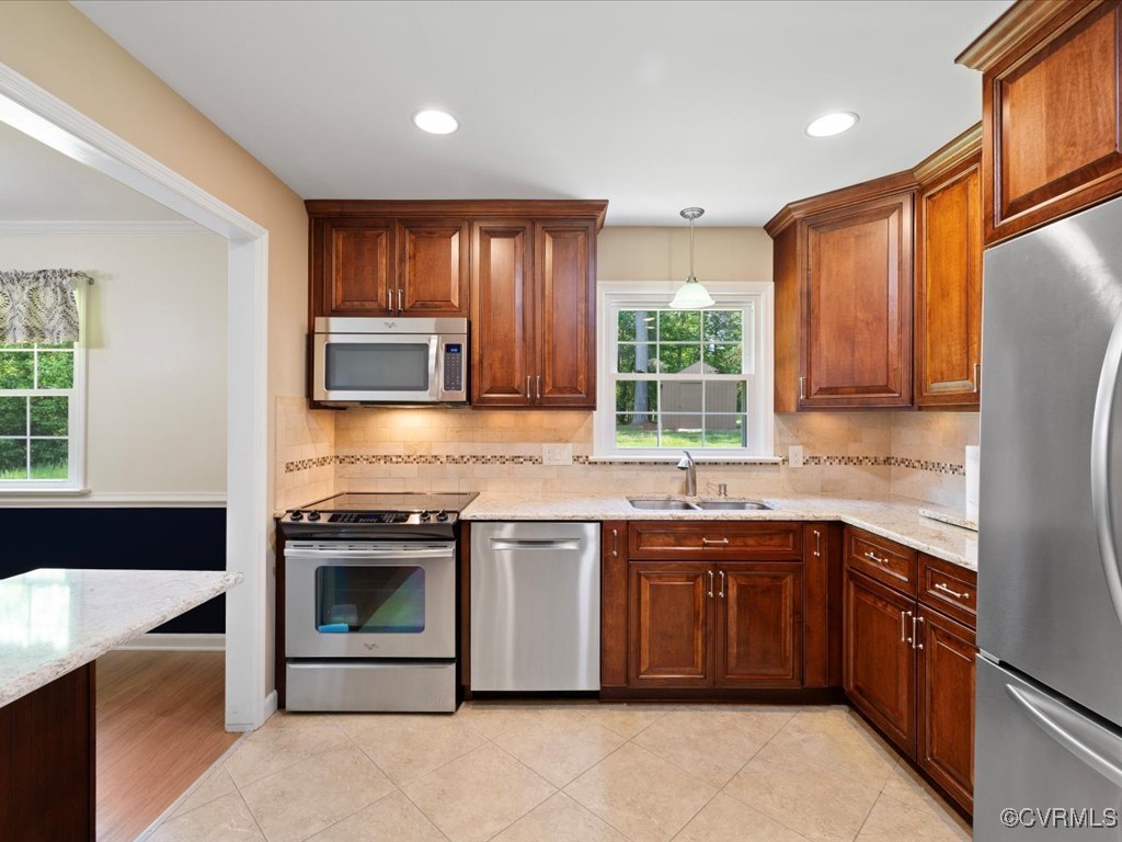 11311 Moravia Road Midlothian, VA 23112 - Photo 13 of 29 a kitchen with stainless steel appliances granite countertop a stove a sink and a microwave