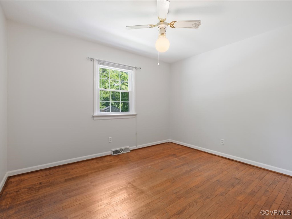 11311 Moravia Road Midlothian, VA 23112 - Photo 19 of 29 an empty room with wooden floor fan and windows