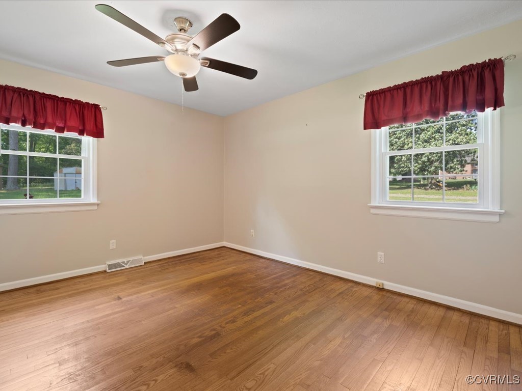 11311 Moravia Road Midlothian, VA 23112 - Photo 22 of 29 a view of an empty room with a window and wooden floor
