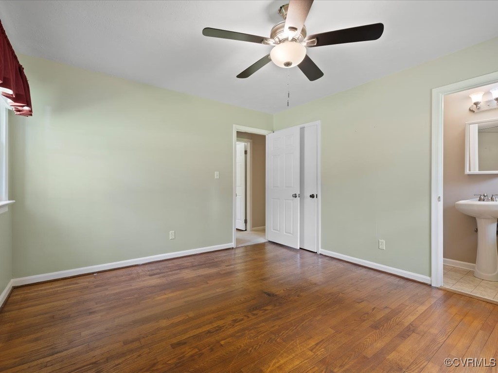 11311 Moravia Road Midlothian, VA 23112 - Photo 23 of 29 an empty room with wooden floor fan and windows
