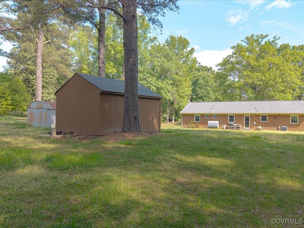 11311 Moravia Road Midlothian, VA 23112 - Photo 3 of 29 a backyard of a house with table and chairs
