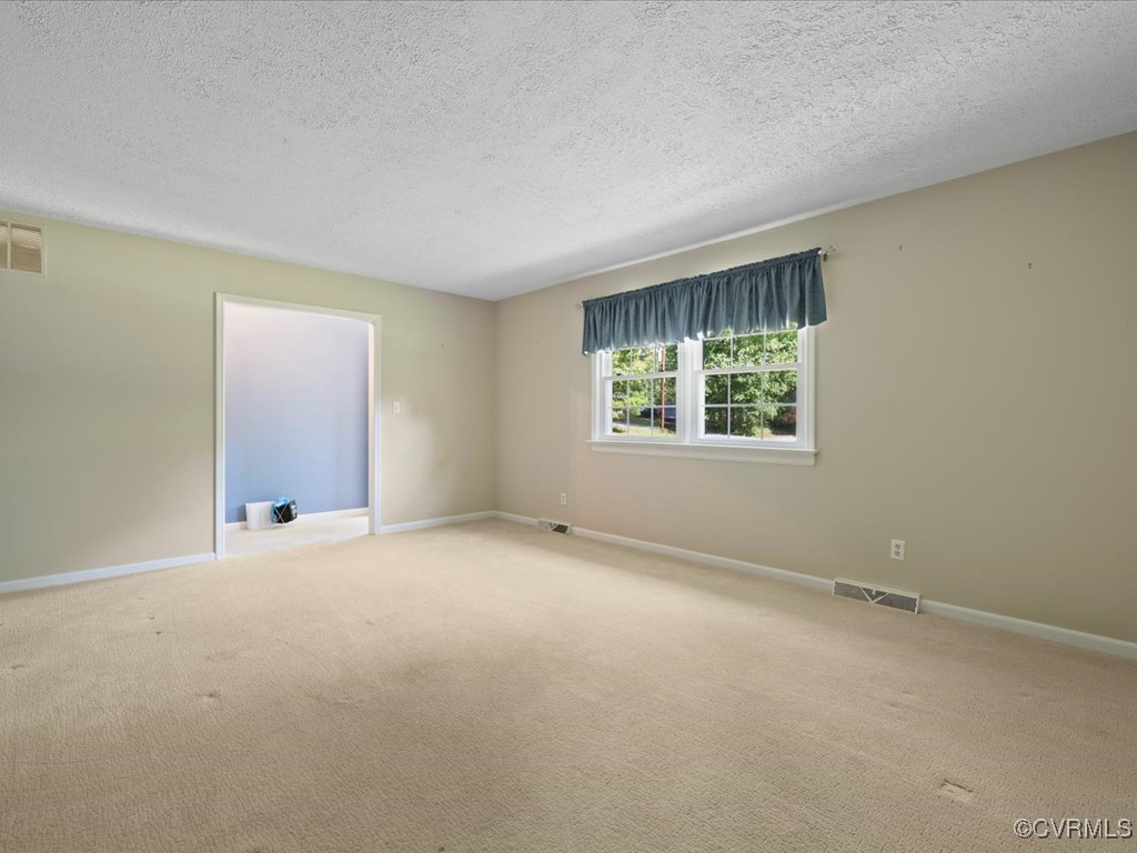 11311 Moravia Road Midlothian, VA 23112 - Photo 6 of 29 an empty room with windows