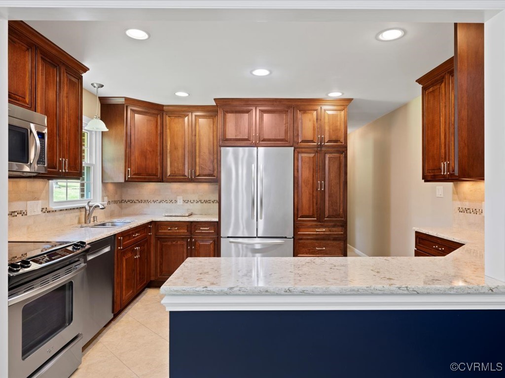11311 Moravia Road Midlothian, VA 23112 - Photo 10 of 29 a kitchen with kitchen island granite countertop wooden cabinets and stainless steel appliances