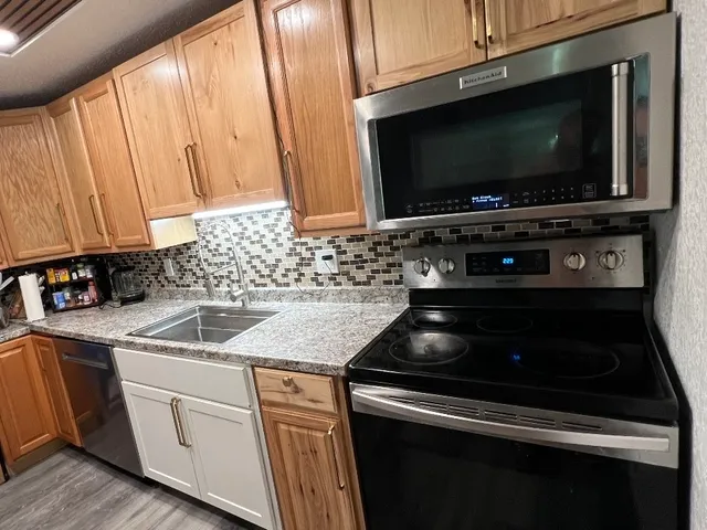 a kitchen with microwave a stove and a microwave