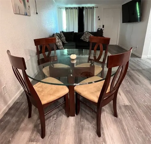a dining room with furniture and wooden floor