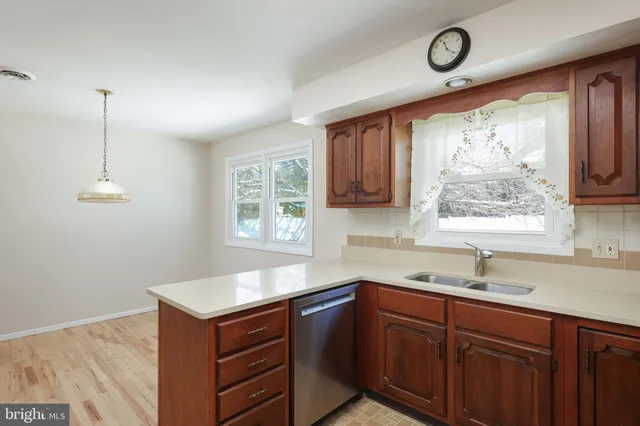 a kitchen with a sink window and cabinets