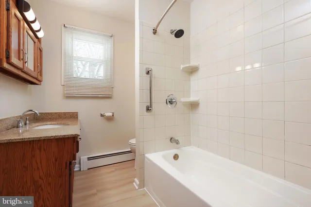 a bathroom with a tub a sink and a shower