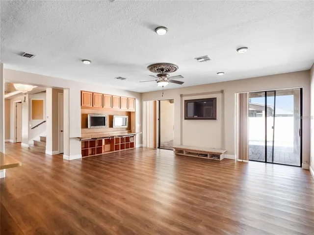 a view of a livingroom with furniture wooden floor and window