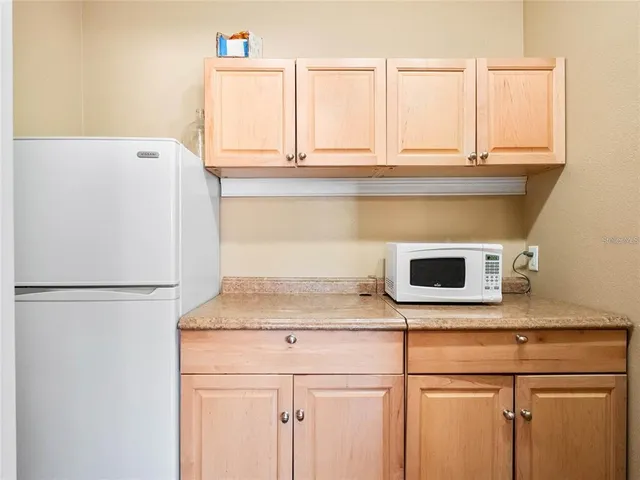 a kitchen with a cabinets and white appliances