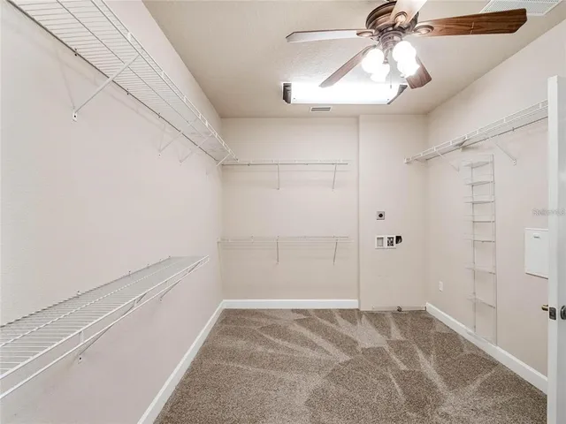 a view of a room with a white ceiling fan