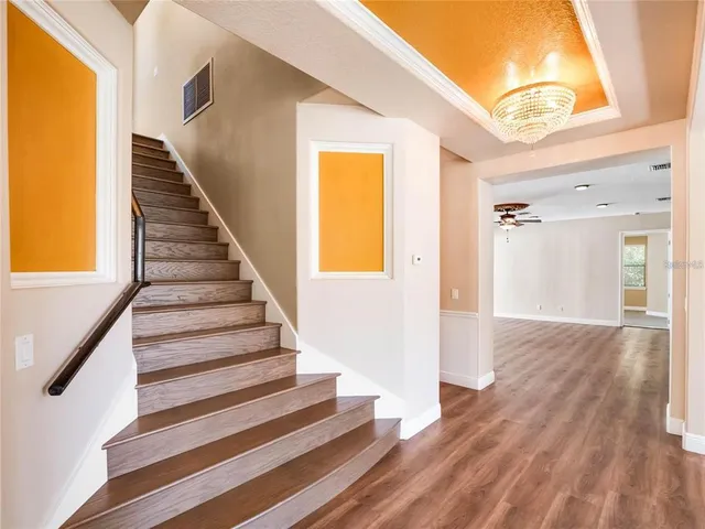 a view of entryway and hall with wooden floor