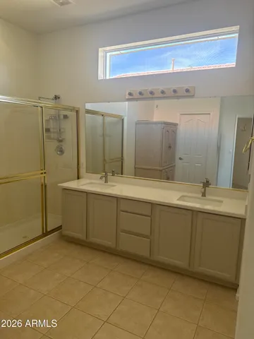 a bathroom with a mirror sink and tub