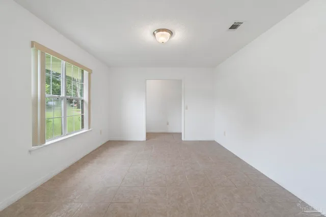 an empty room with windows and closet