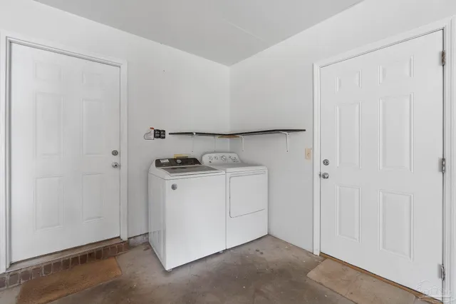 a utility room with cabinets washer and dryer