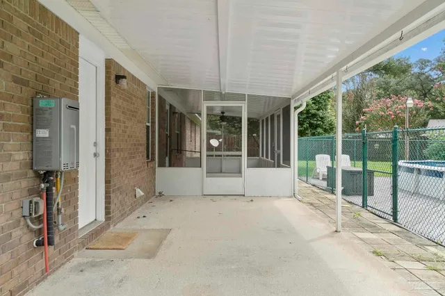 a view of a porch with furniture and garden