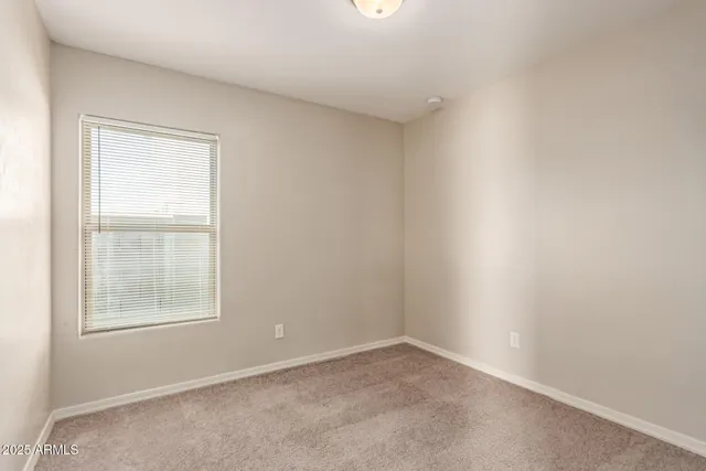 an empty room with closet and entryway