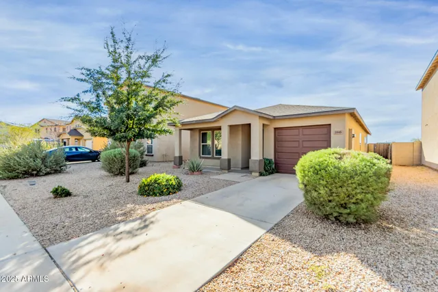 a front view of a house with garden