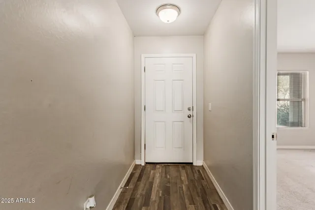 a view of a room with wooden floor and a sink