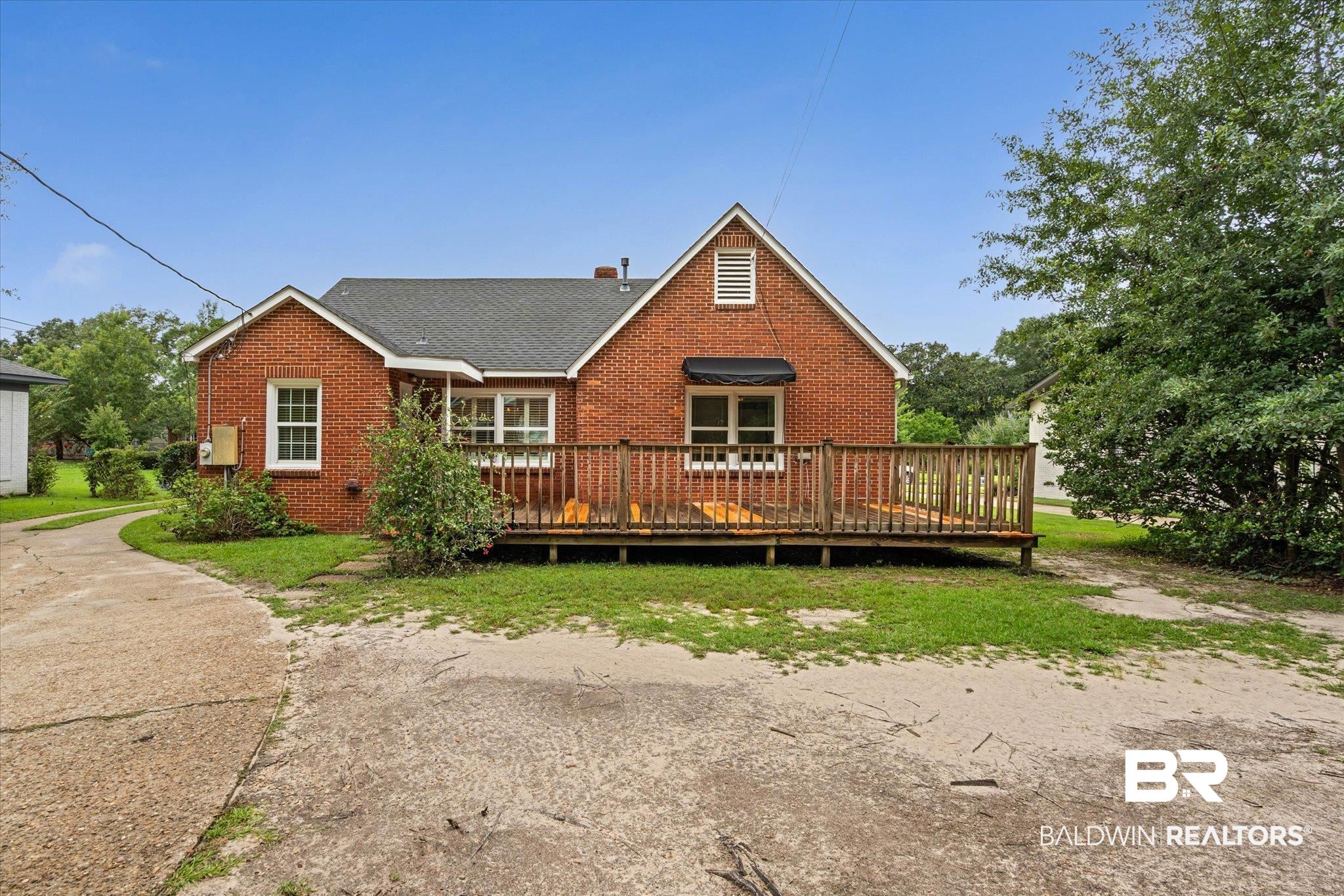 300 Woodlands Avenue Mobile, AL 36607 - Photo 16 of 23 Rear view of property featuring brick siding, a deck, and a shingled roof