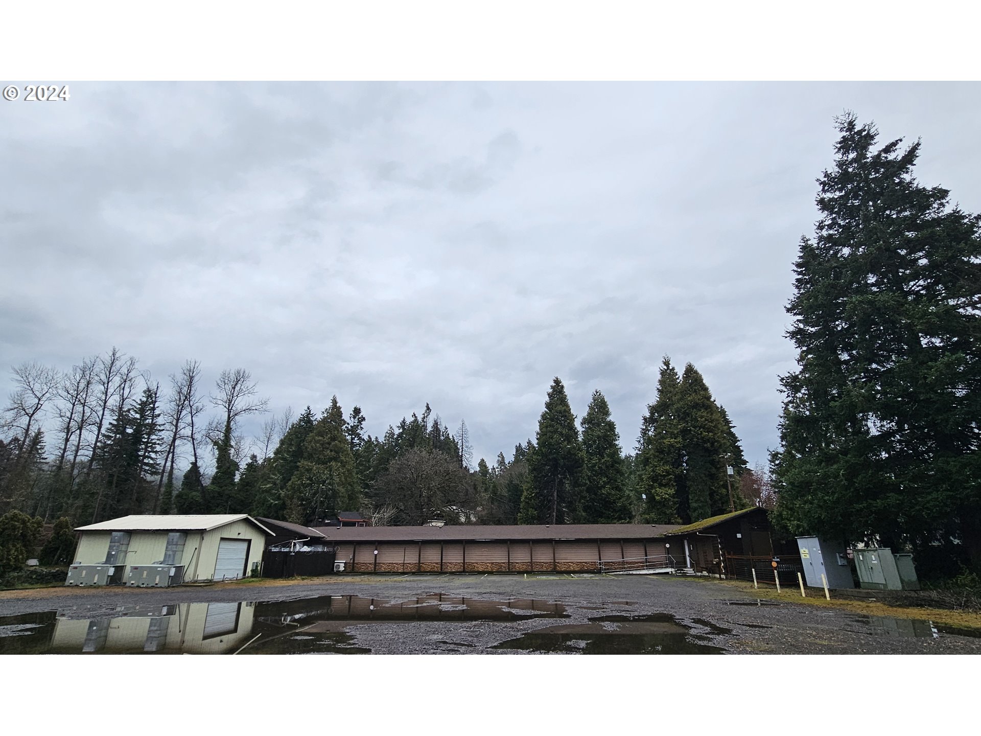 48197 Highway 58 Oakridge, OR 97463 - Photo 2 of 8 a view of house with tall trees in front of it