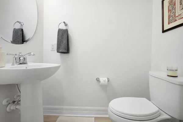 a bathroom with a sink vanity mirror and toilet