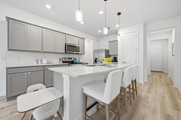 a kitchen with a sink a microwave and cabinets