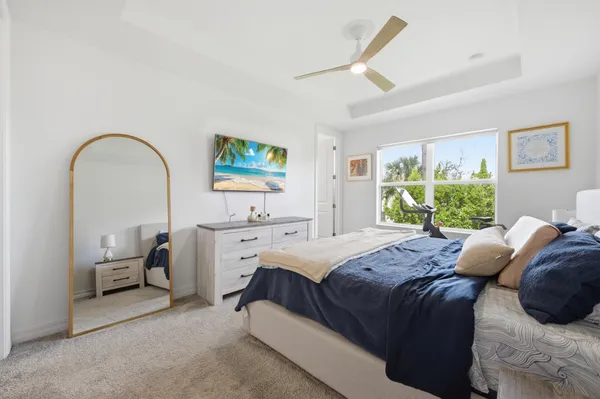 a bedroom with a bed a table and window