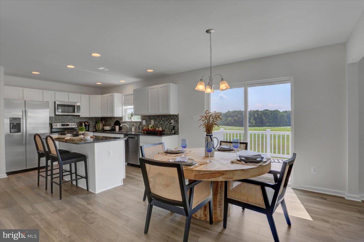 2115 B Nuttal Avenue Edgewood, MD 21040 - Photo 7 of 19 a kitchen with a dining table chairs and white cabinets