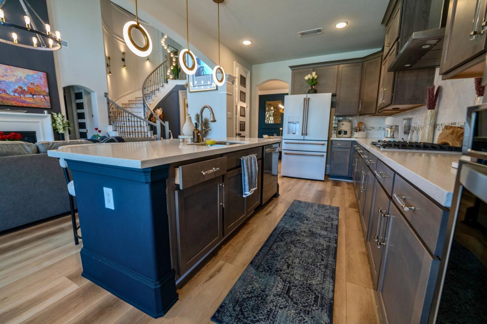 11347 Needlerock Court Humble, TX 77396 - Photo 8 of 20 a large kitchen with stainless steel appliances granite countertop a large stove top oven a sink dishwasher and wooden cabinets with wooden floor