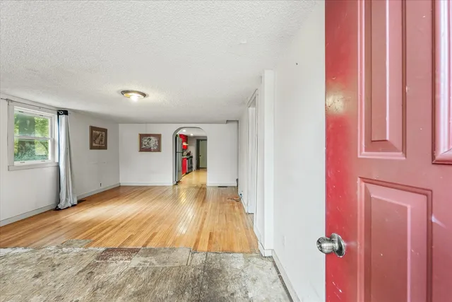 a view of a livingroom with wooden floor and a window