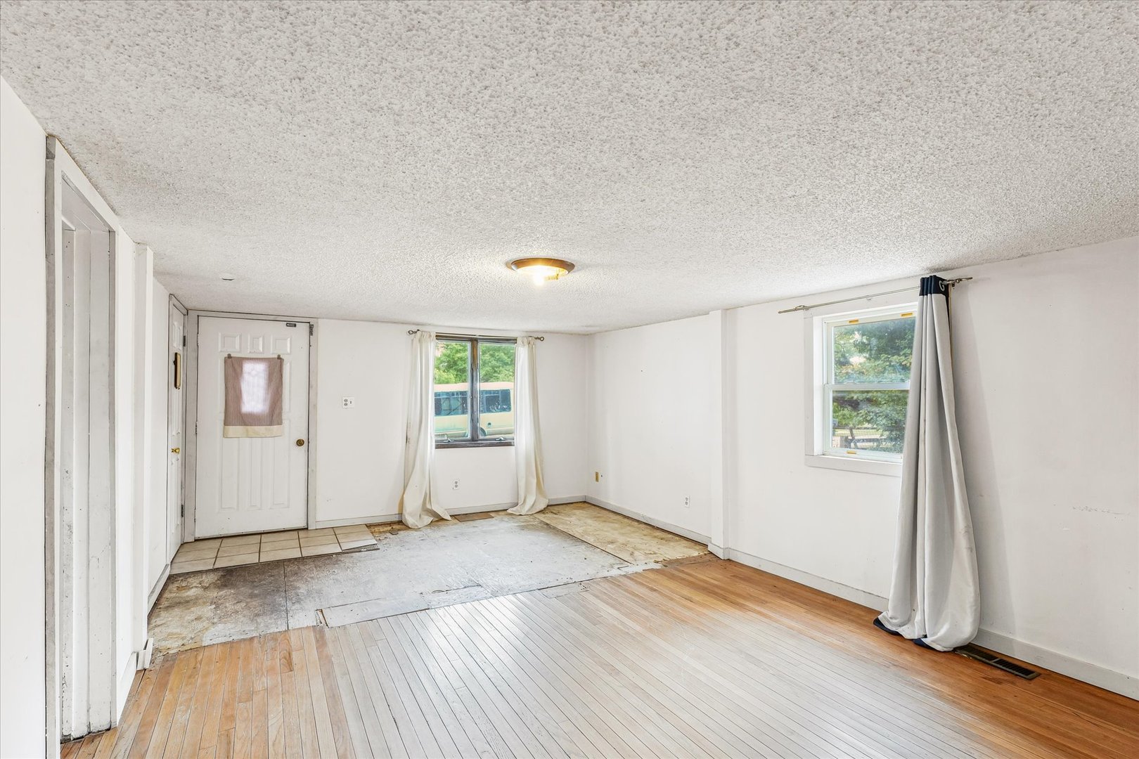 204 Waverly Street Homer, IL 61849 - Photo 8 of 30 an empty room with wooden floor and windows