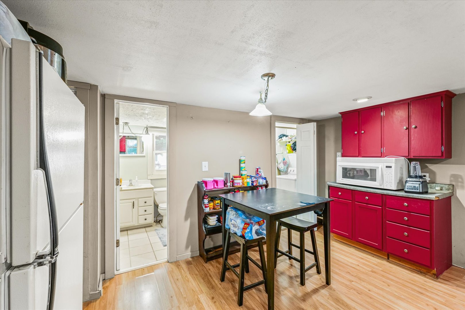 204 Waverly Street Homer, IL 61849 - Photo 10 of 30 a kitchen with stainless steel appliances granite countertop a dining table cabinets and wooden floor